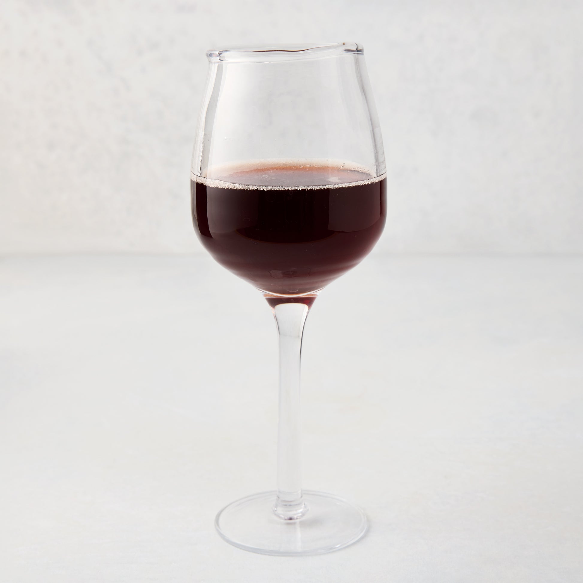 Elijah Large Scissor-Cut Wine Glass, 14 oz, clear thick air-blown glass with red wine.