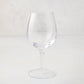 Elijah Small Scissor-Cut 12 oz. clear, thick air-blown glass wine glass with rippled rim.