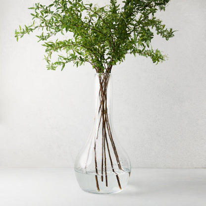 Elise Glass Vase, 19.5"H, mouth-blown clear glass, traditional shape, with green leafy stems.