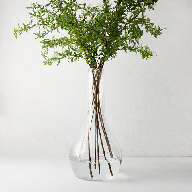 Elise Glass Vase, 19.5"H, mouth-blown clear glass, traditional shape, with green leafy stems.