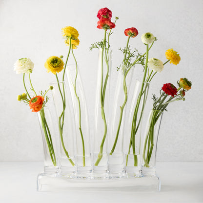 Elli Large Scissor-Cut Glass Vase with multiple clear glass tubes holding colorful ranunculus flowers.