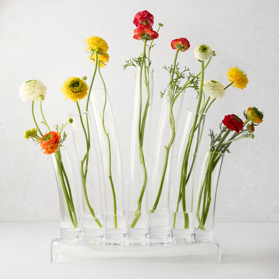 Elli Large Scissor-Cut Glass Vase with multiple clear glass tubes holding colorful ranunculus flowers.
