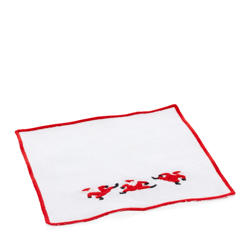White linen coaster with red embroidered Santa figures and a red border.