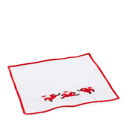 White linen coaster with red embroidered Santa figures and a red border.