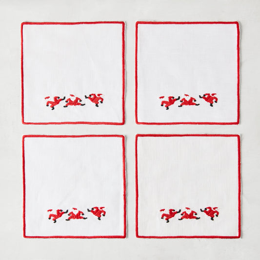 Set of 4 white linen Christmas coasters with red embroidered Santa figures and red border, 5.5" square.