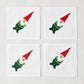 Set of 4 white linen 5.5" square cocktail napkins with embroidered gnomes in red hats and green outfits.