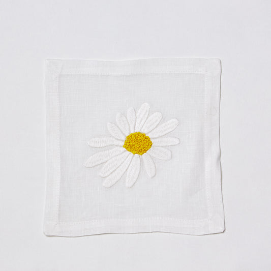 White linen 6" square coaster with hand-embroidered white and yellow daisy.