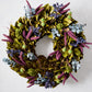 Enchanted Forest Wreath with green magnolia leaves, blue juniper berries, plum millet, and green magnolia pods.