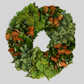 Hudson Grace 18-inch Evergreen Trinity Wreath featuring layered green cedar, pine needles, and brown magnolia leaves.