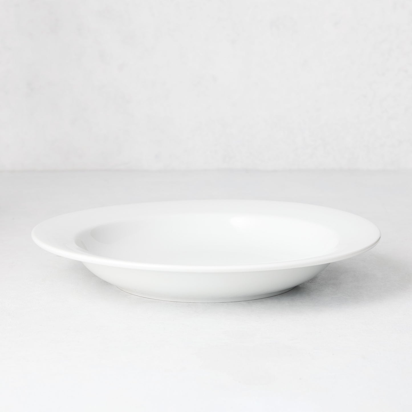 Everyday Porcelain Bowl, a classic white soup bowl with a wide rim.