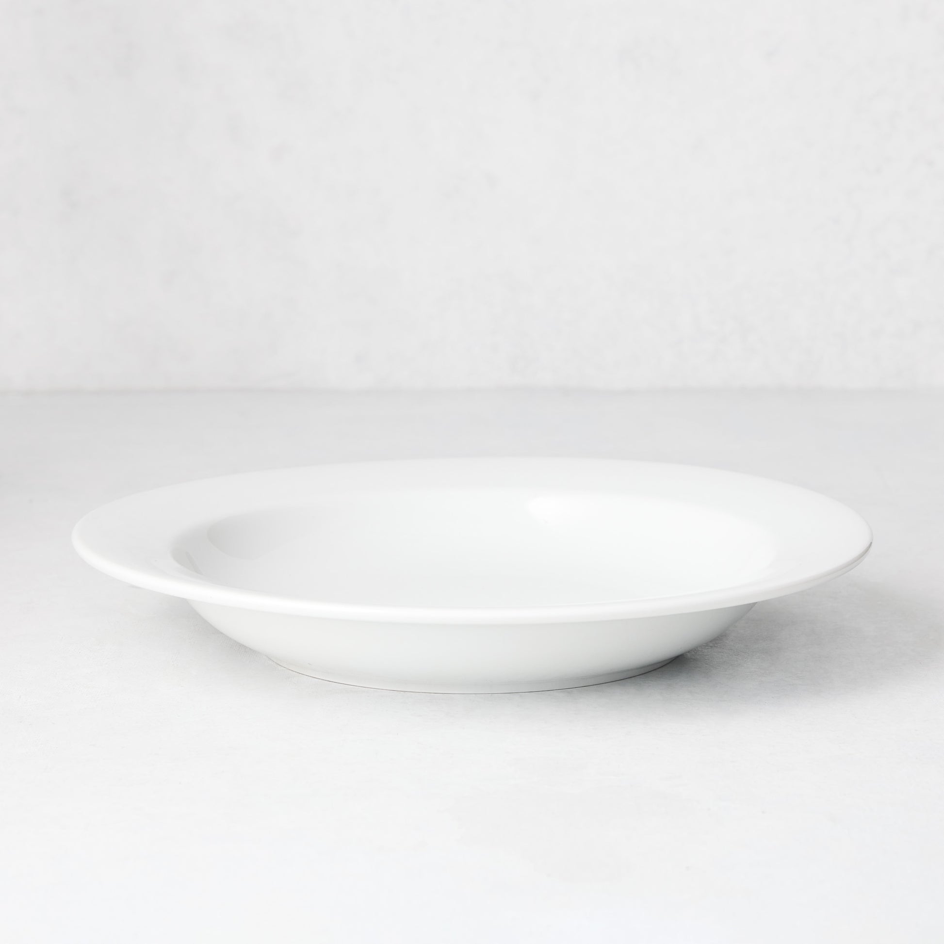 Everyday Porcelain Bowl, a classic white soup bowl with a wide rim.