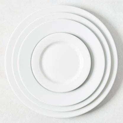 Hudson Grace Everyday Porcelain Buffet Plate, 12.2" Dia, white, classic rim, stacked with smaller plates.