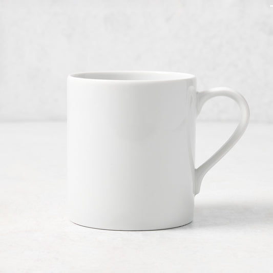 White porcelain mug with a curved handle from the Hudson Grace Everyday collection, 4.3 inches tall.