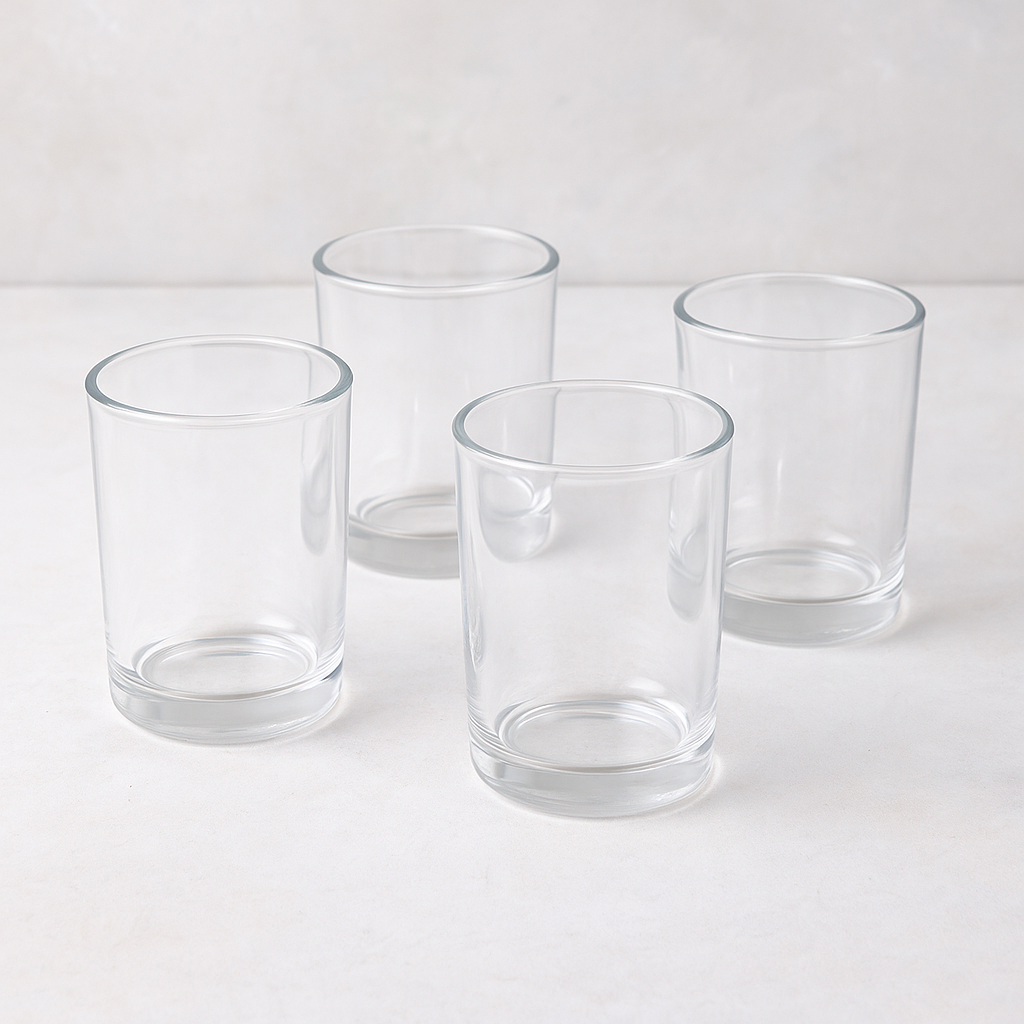 Set of four clear, simple, cylindrical Hudson Grace Everyday Wine Glasses on a light surface.