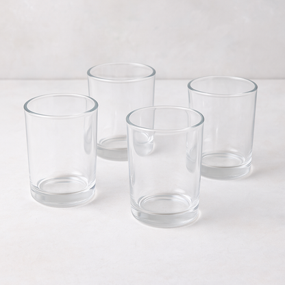 Set of four clear, simple, cylindrical Hudson Grace Everyday Wine Glasses on a light surface.