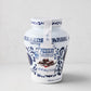 White ceramic Fabbri Amarena cherries jar with blue floral design and product label.