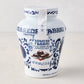 White ceramic Fabbri Amarena cherries jar with blue floral design and product label.