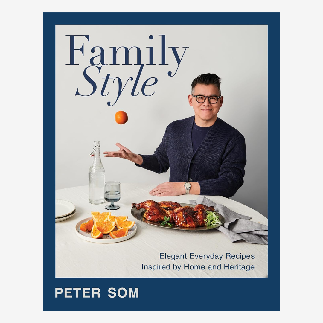 Family Style cookbook cover featuring Peter Som at a table with roasted chicken, orange slices, and a floating orange.