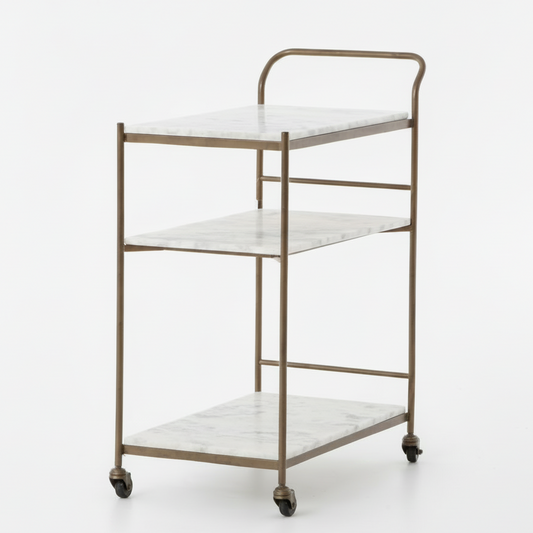 Felix antique brass bar cart with three white marble rectangular shelves on casters.
