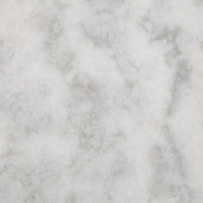 White marble with subtle grey veining, a close-up texture.
