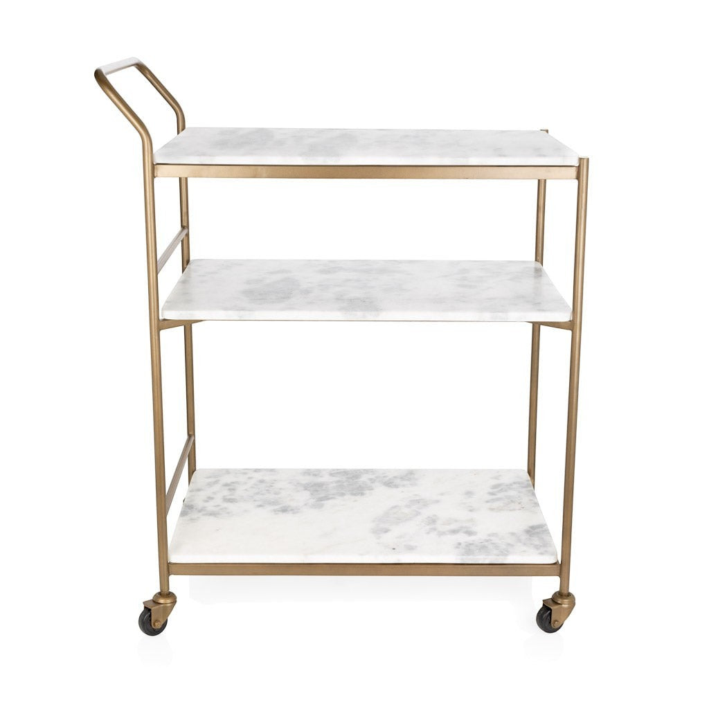Felix antique brass bar cart with three rectangular white marble shelves and casters.