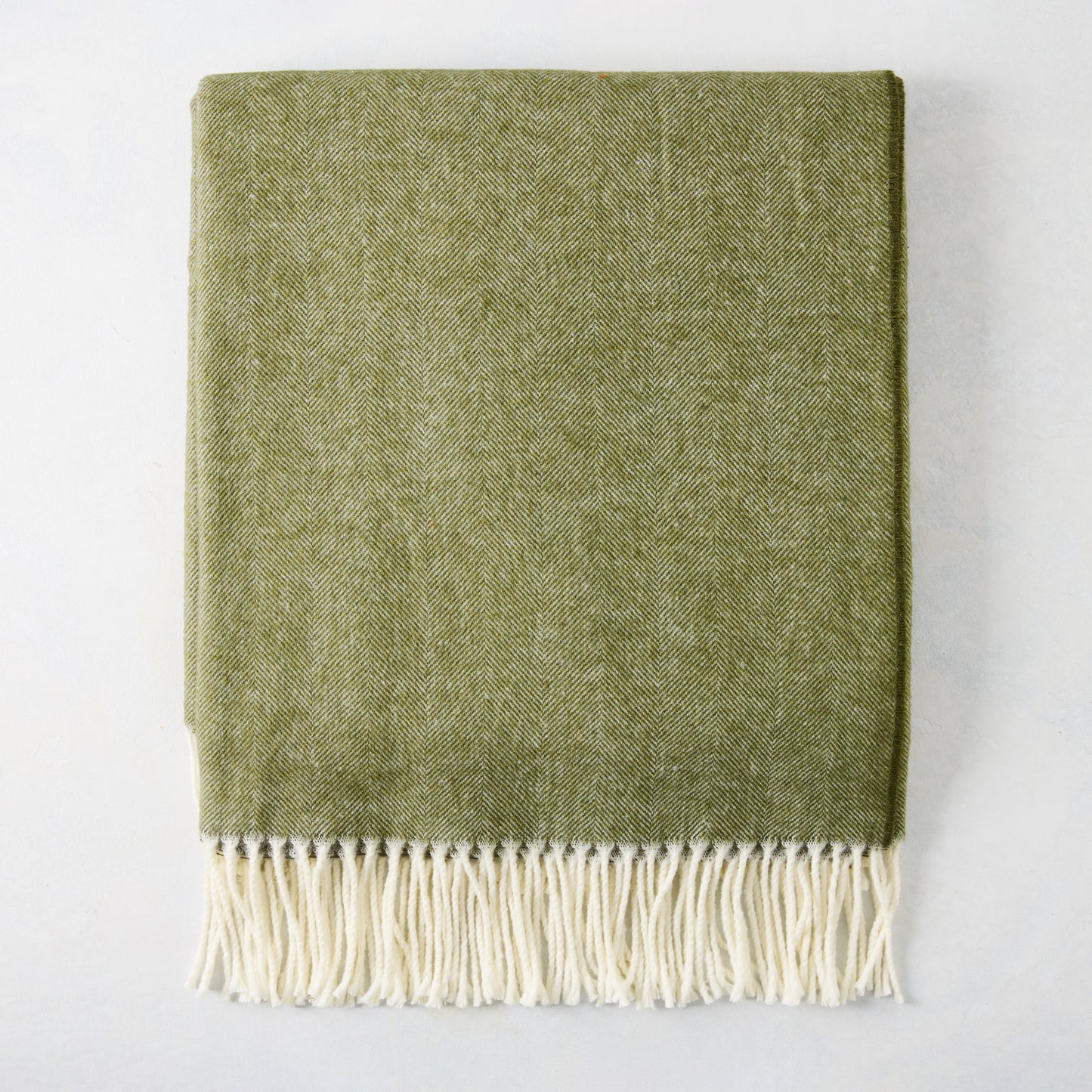 Fern Green Italian Herringbone Throw Blanket, 51"W x 67"L, with decorative cream fringe.