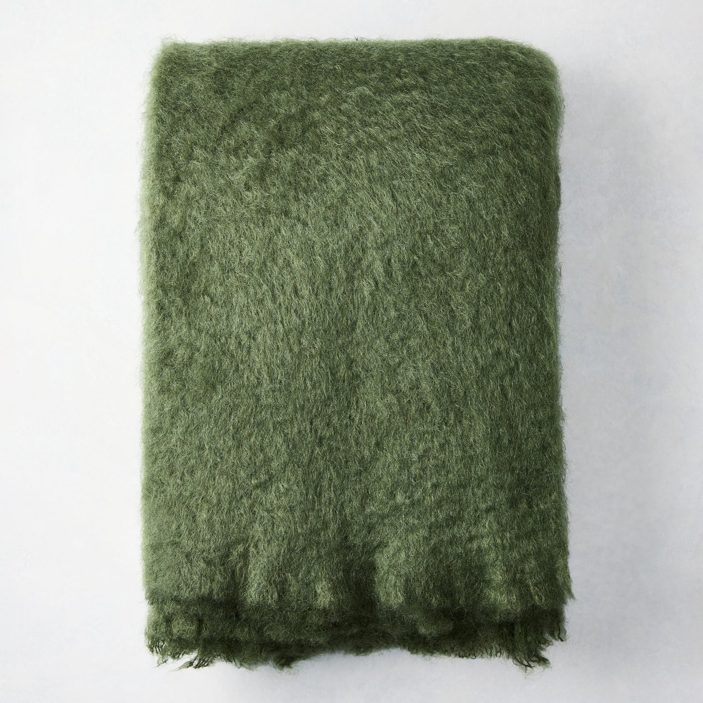 Folded Fern Green Mohair Throw Blanket, 72"L x 51"W, with a soft, shaggy texture.