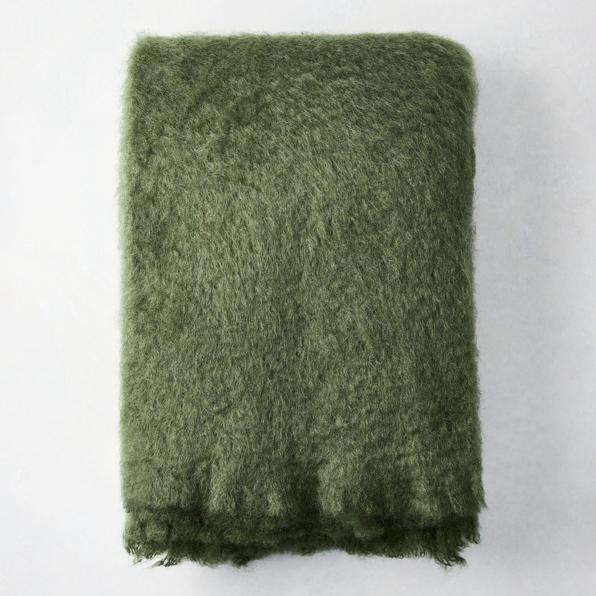 Folded Fern Green Mohair Throw Blanket, 72"L x 51"W, with a soft, shaggy texture.