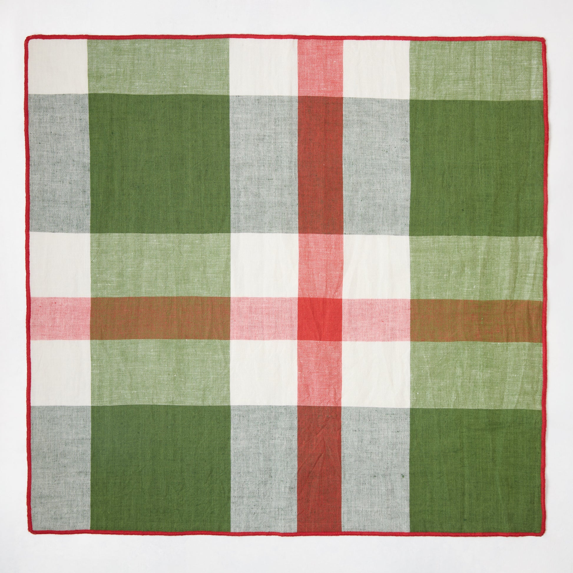 Festive green, red, and white plaid cotton napkin with embroidered red trim, 22" square.