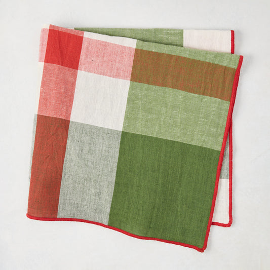 Festive green and red plaid cotton napkin with embroidered red trim, 22" square.
