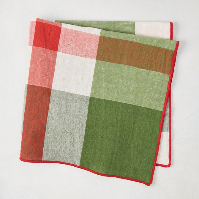 Festive green and red plaid cotton napkin with embroidered red trim, 22" square.