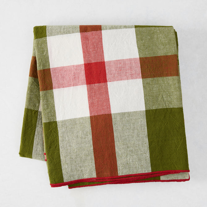 Folded Festive Green and Red Plaid Tablecloth with embroidered red trim, 100% cotton.