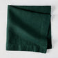 Fir HG Hand-dyed Linen Napkin, dark forest green, folded square, 22-inch, mitered corners.