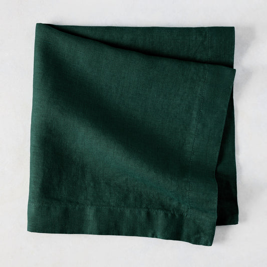 Fir HG Hand-dyed Linen Napkin, dark forest green, folded square, 22-inch, mitered corners.