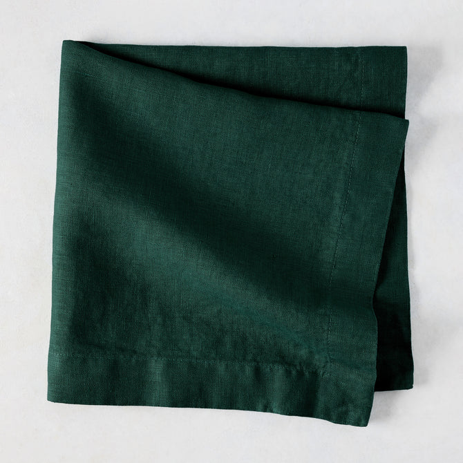 Fir HG Hand-dyed Linen Napkin, dark forest green, folded square, 22-inch, mitered corners.