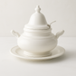 White ceramic Firenze soup tureen with lid, ladle, and matching underplate.