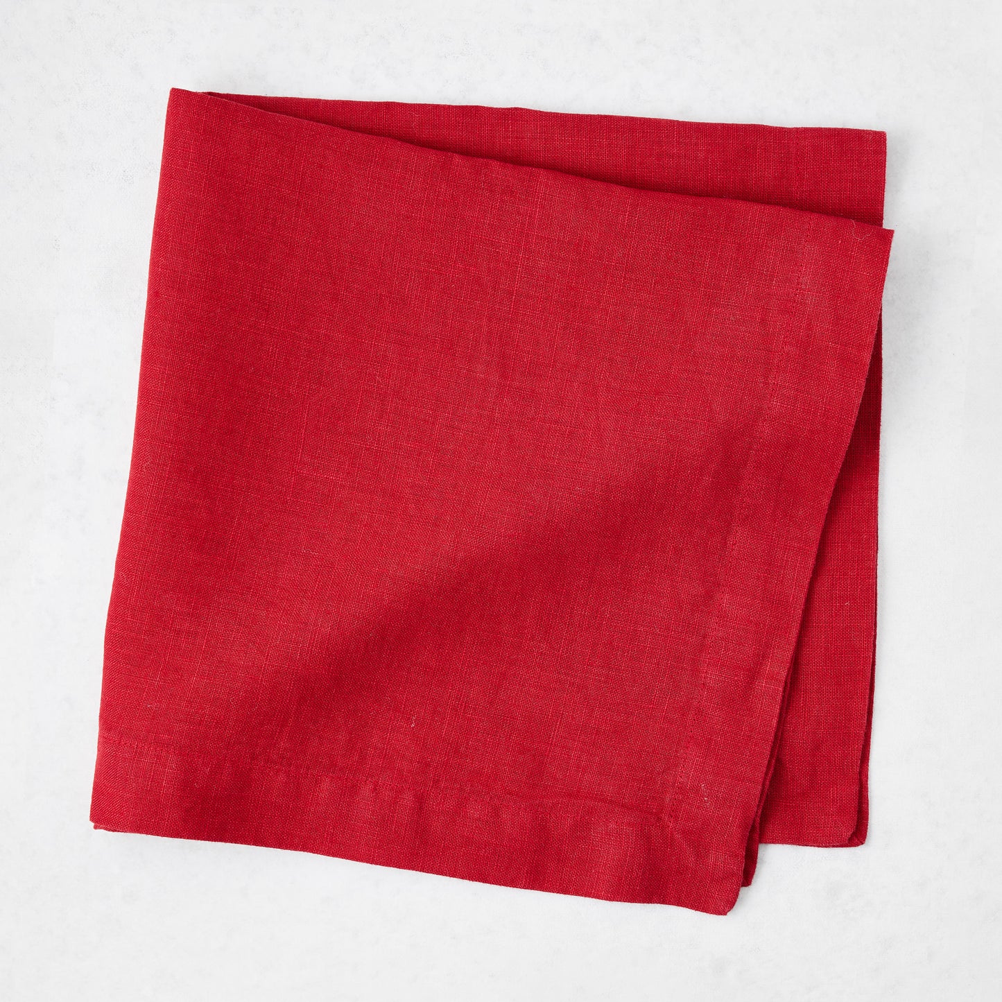 Flame red 22-inch square hand-dyed linen napkin with mitered corners on a white background.