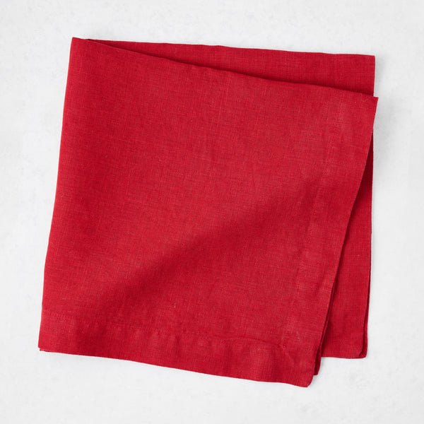 Flame red 22-inch square hand-dyed linen napkin with mitered corners on a white background.