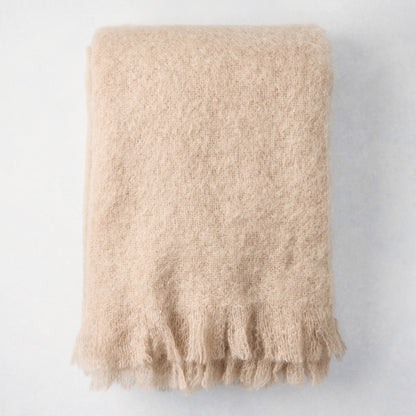 Folded Flax Beige Mohair Throw Blanket, 72"L x 51"W, with fringed edges.
