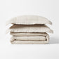 Stacked natural flax linen quilted coverlet and two shams, 88"W x 92"L.