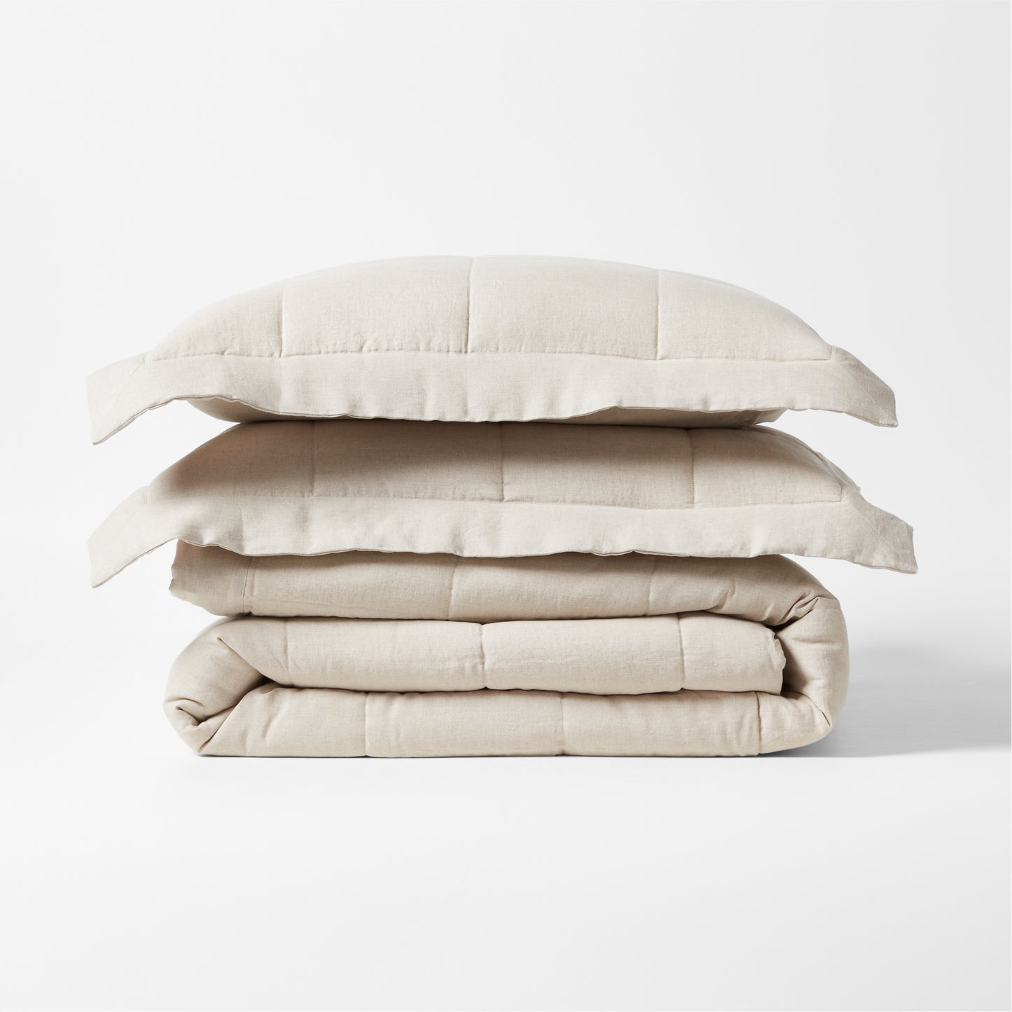 Stacked natural flax linen quilted coverlet and two shams, 88"W x 92"L.