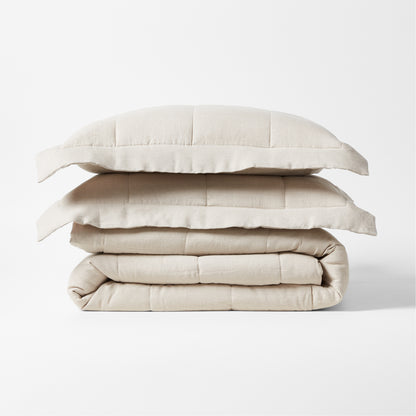 Stacked natural flax linen quilted coverlet and two shams, 88"W x 92"L.