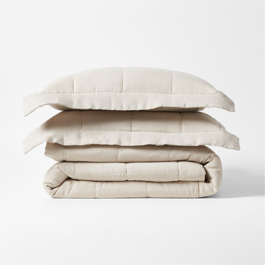 Stacked natural flax linen quilted coverlet and two shams, 88"W x 92"L.