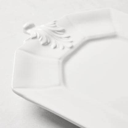 White octagon ceramic serving platter with raised Fleur de Lys detail.