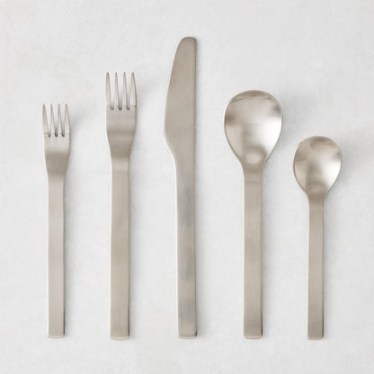 Flint 5-piece flatware set in polished 18/10 stainless steel with a modern, minimalist, rounded design.