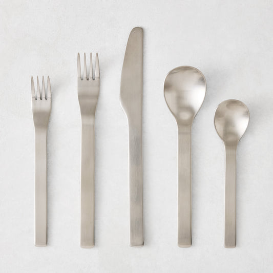 Flint 5-piece flatware set in polished 18/10 stainless steel with a modern, minimalist, rounded design.