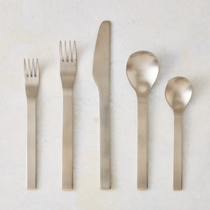 Flint 5-piece flatware set in polished 18/10 stainless steel with a modern, minimal, and rounded design.