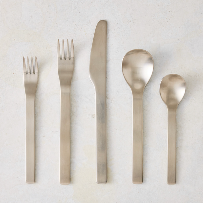 Flint 5-piece flatware set in polished 18/10 stainless steel with a modern, minimal, and rounded design.