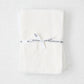 Stack of 6 white cotton flour sack towels, tied with a white "Hudson Grace" ribbon.