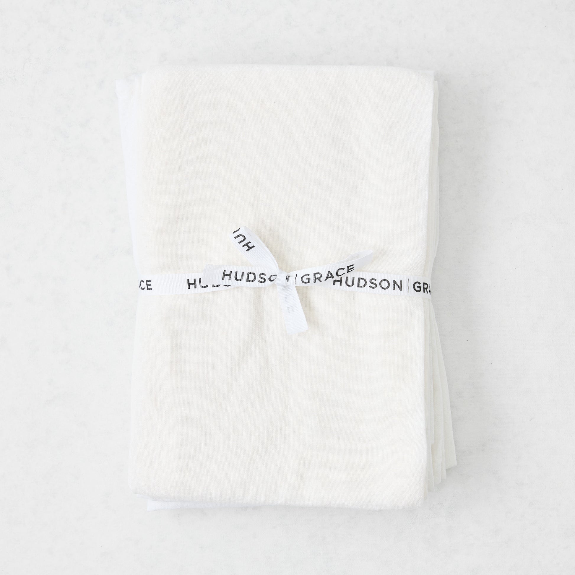 Stack of 6 white cotton flour sack towels, tied with a white "Hudson Grace" ribbon.